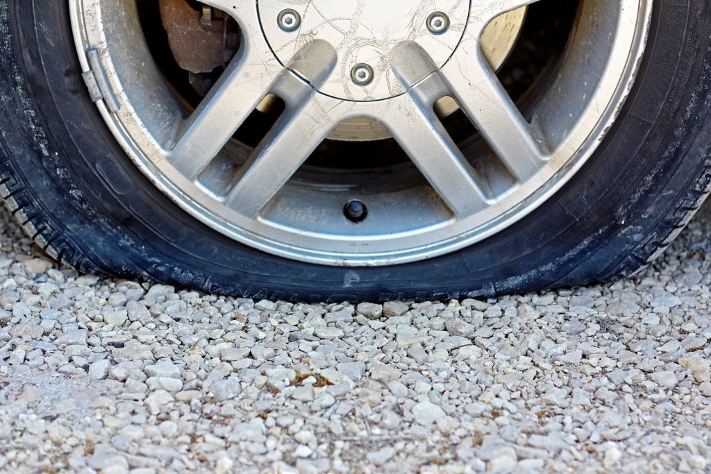 image showing scratched wheel with flat tyre