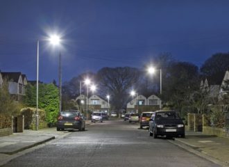 is it illegal to park in front of a driveway? image shows cars at night parked on the pavement