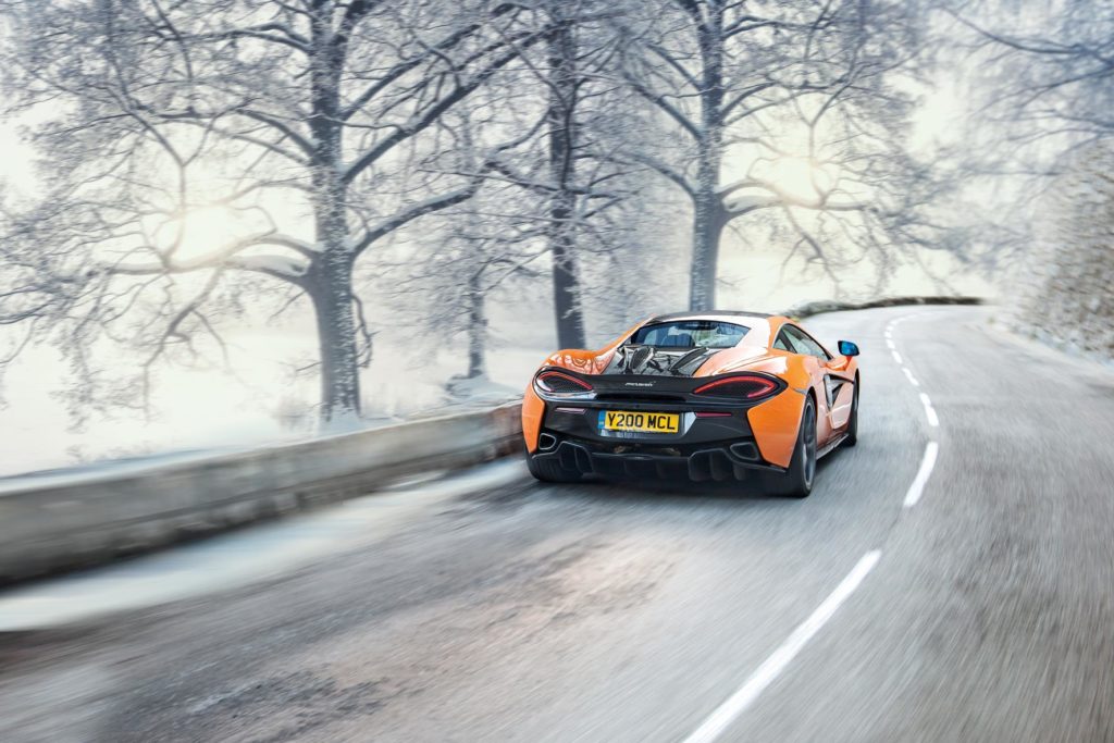 use winter tyres in summer. image showing mclaren on a snowy road
