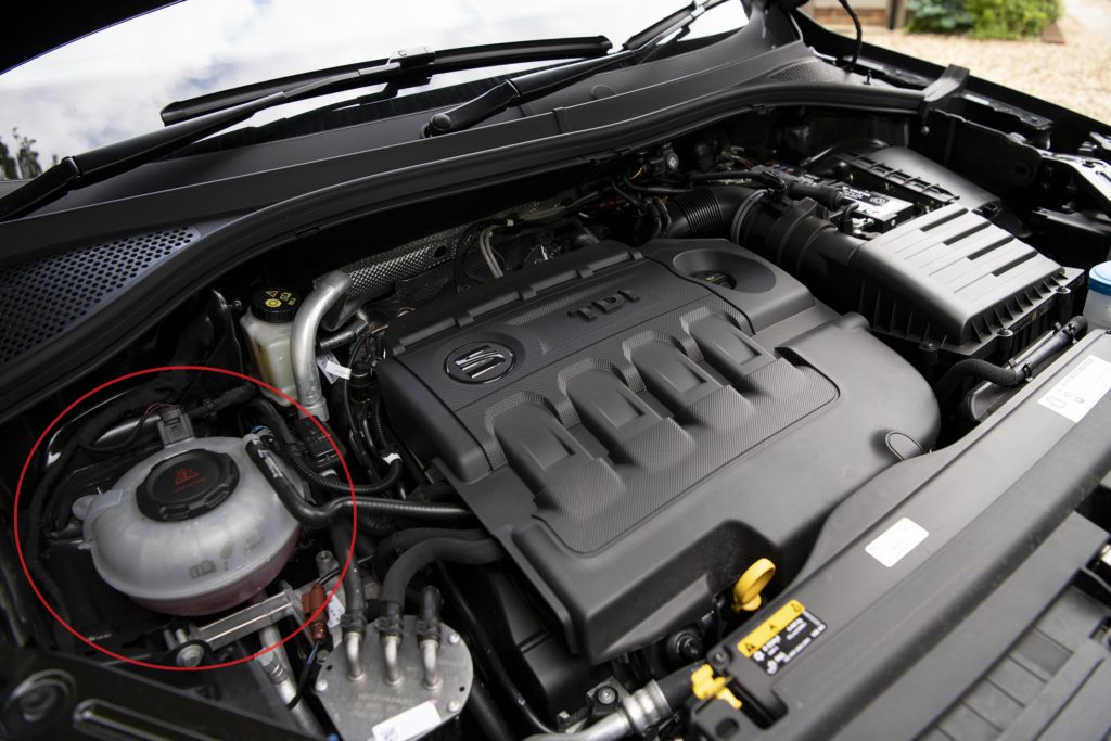 image showing car engine with coolant bottle highlighted